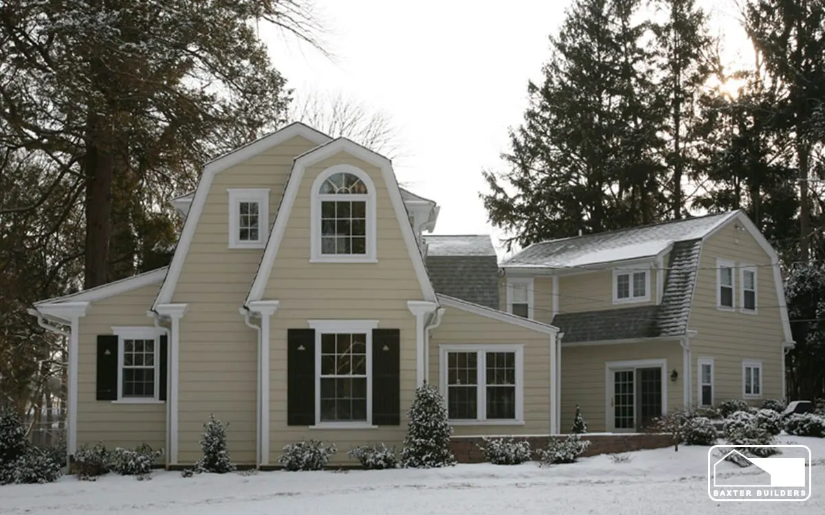 Side view of a gambrel-roof addition on a colonial home