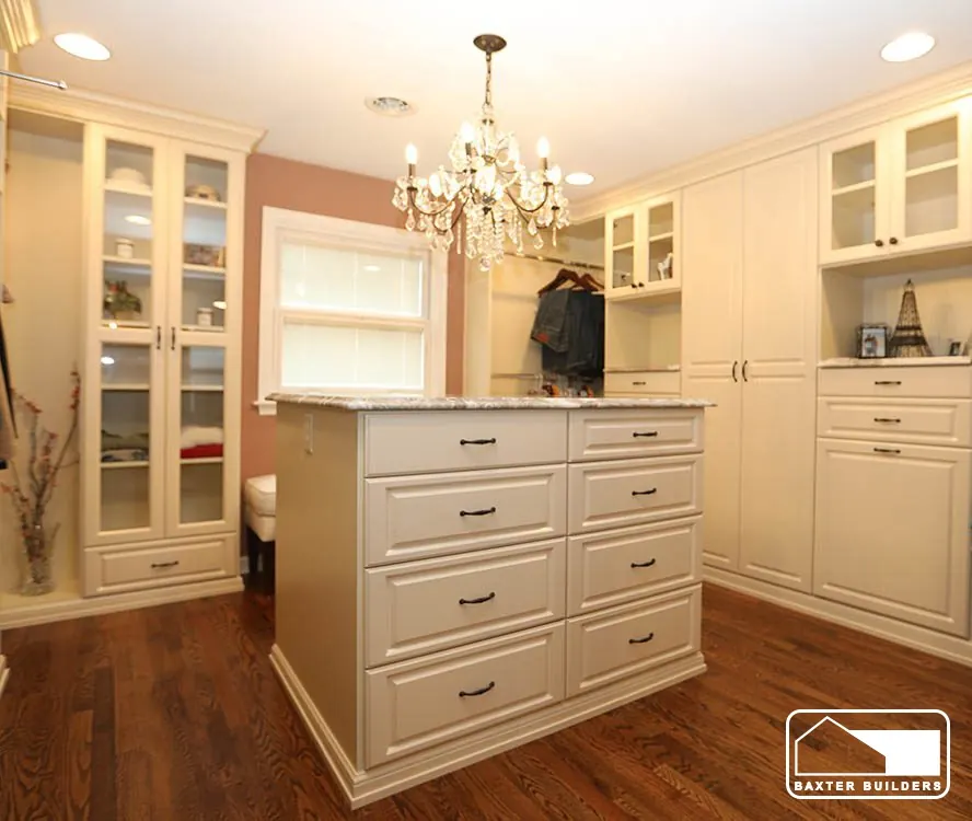 Custom dressing room with built-in cabinetry and chandelier