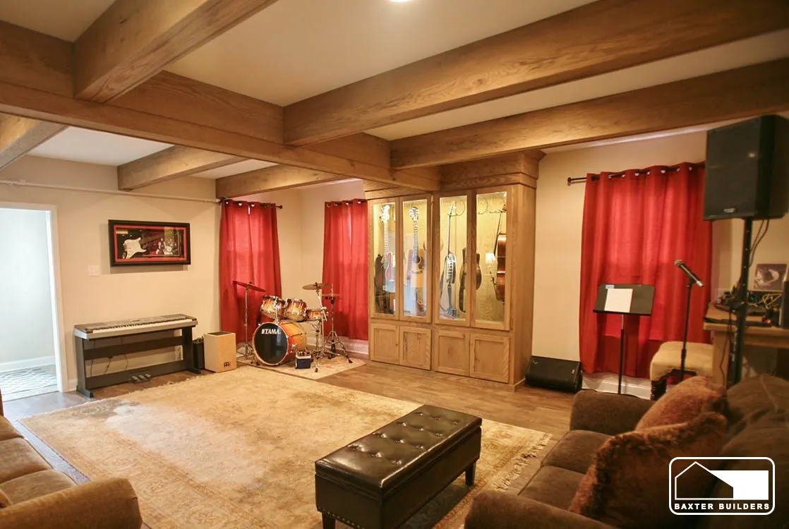 Family room addition with exposed beams and built-in cabinetry