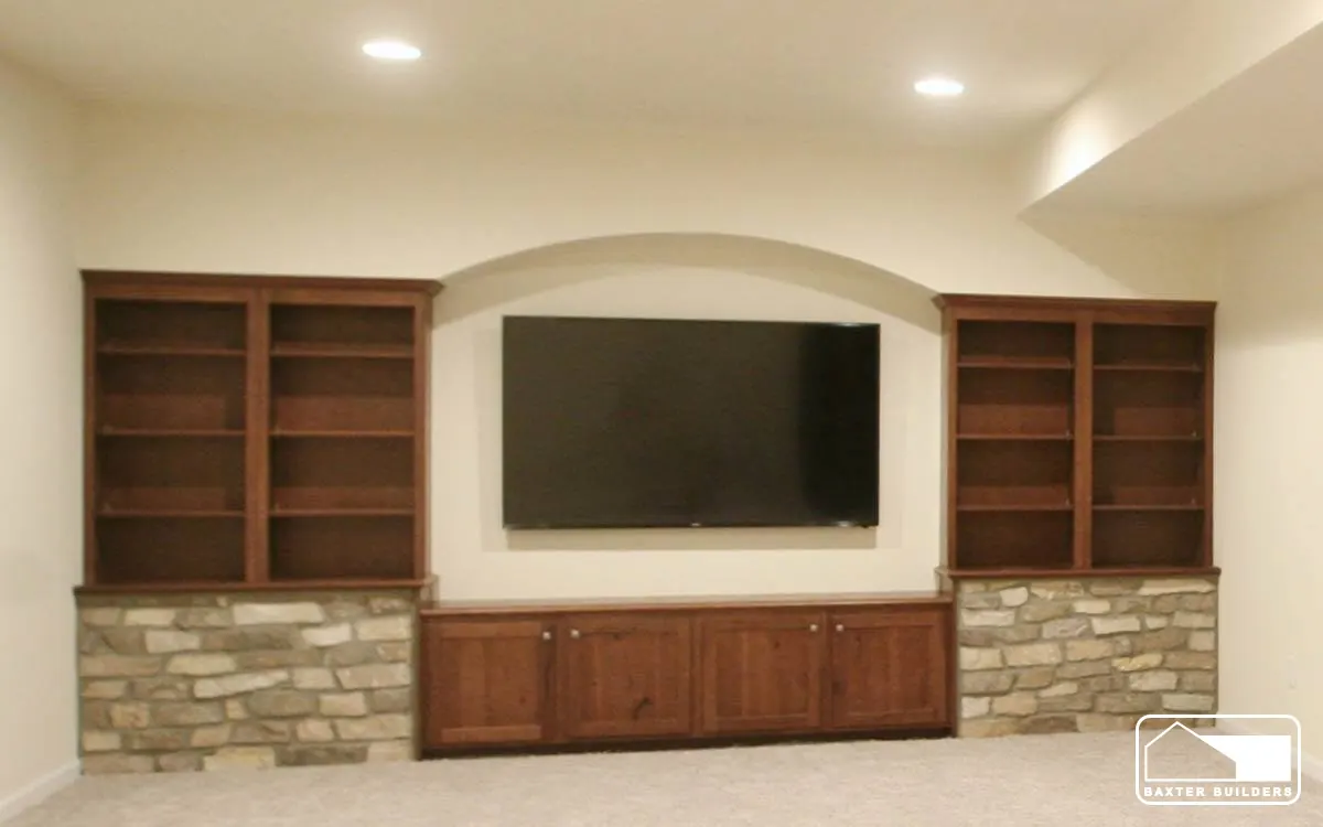 Basement media wall with stone base and built-in bookcases