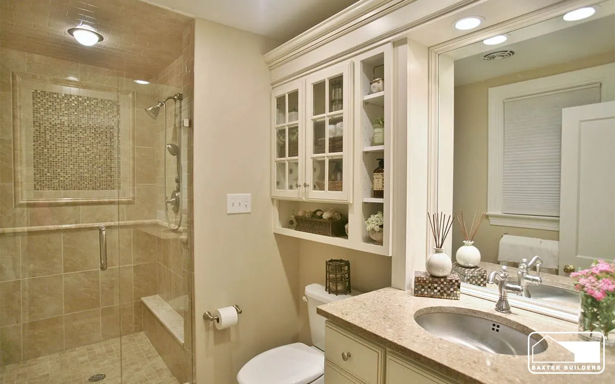 Bathroom with tiled shower, built-in glass cabinets and stone vanity