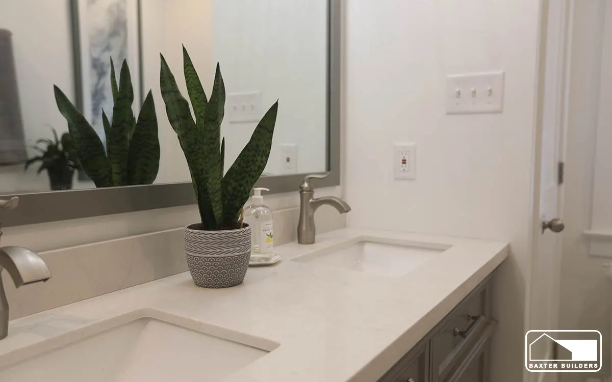 White quartz vanity with undermount sinks and potted plants